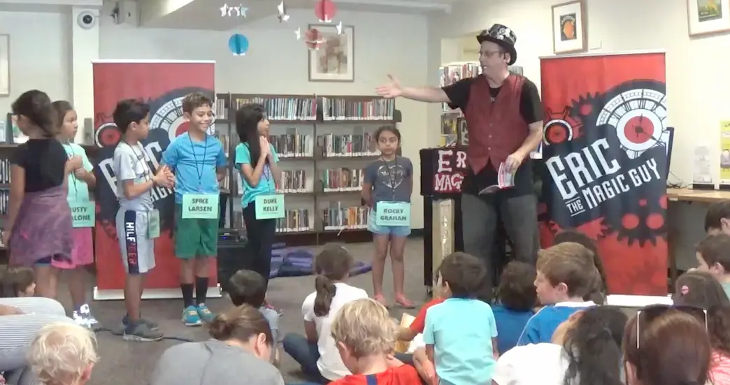 Eric performing magic at a library